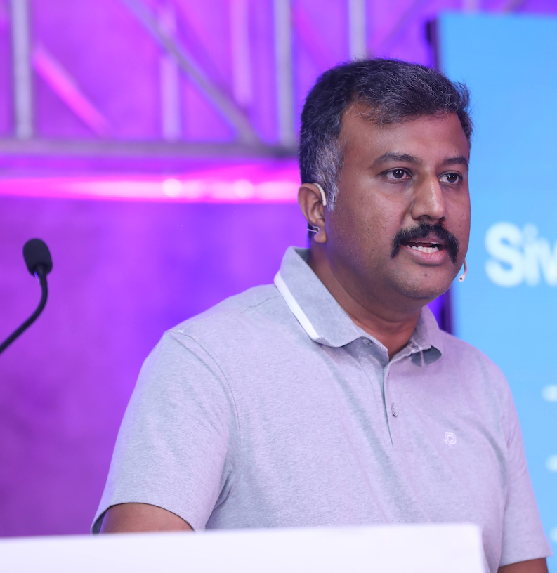 Profile Picture of Adrián Moreno (@zetxek), working side by side with a colleague: sitting on a desk, while looking at a screen